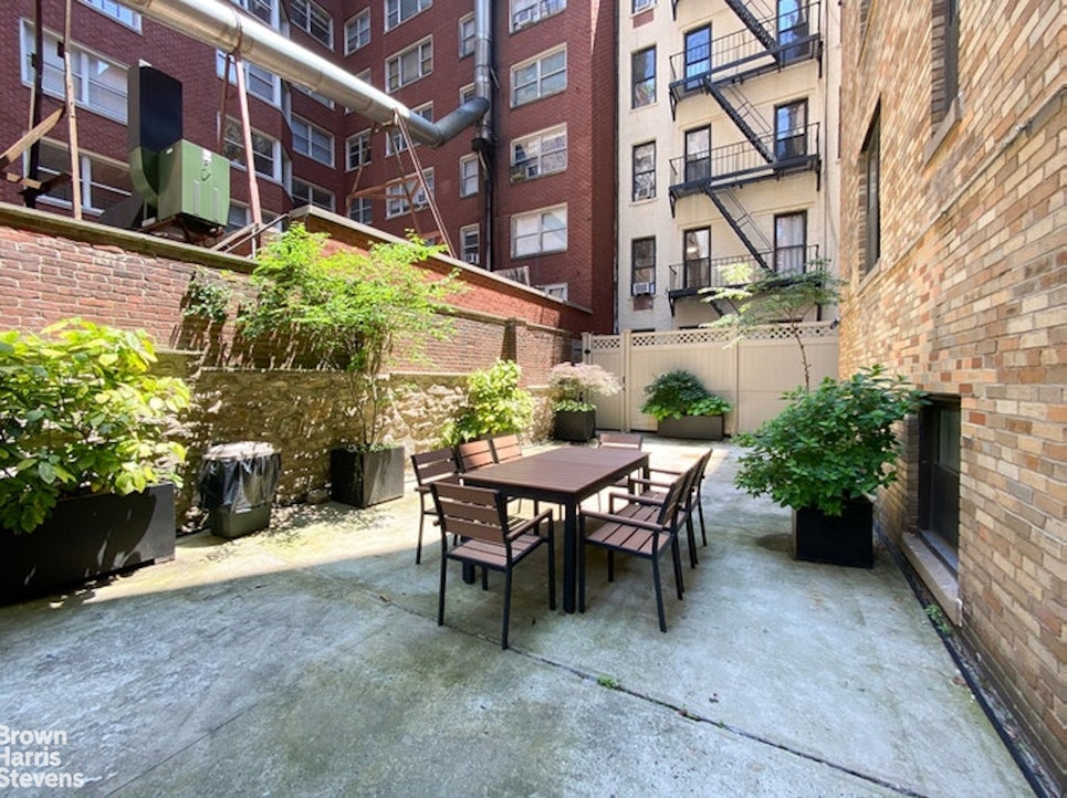 245 East 72nd Street, Unit 11A Manhattan, NY 10021 - Photo 14 of 16 a view of a patio with a table and chairs and potted plants