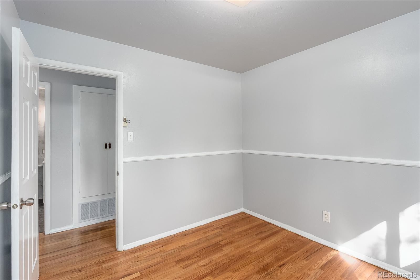 3217 South Stuart Street Denver, CO 80236 - Photo 12 of 30 wooden floor in an empty room