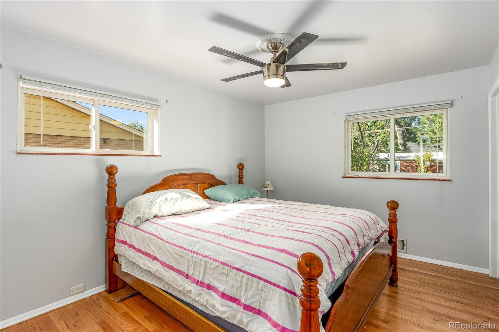 3217 South Stuart Street Denver, CO 80236 - Photo 18 of 30 a bedroom with a bed and a window