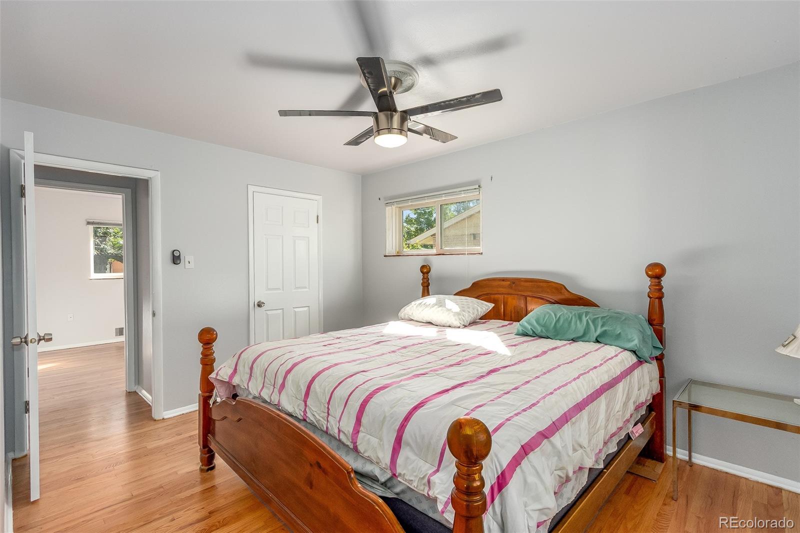 3217 South Stuart Street Denver, CO 80236 - Photo 20 of 30 a bedroom with bed and a chandelier