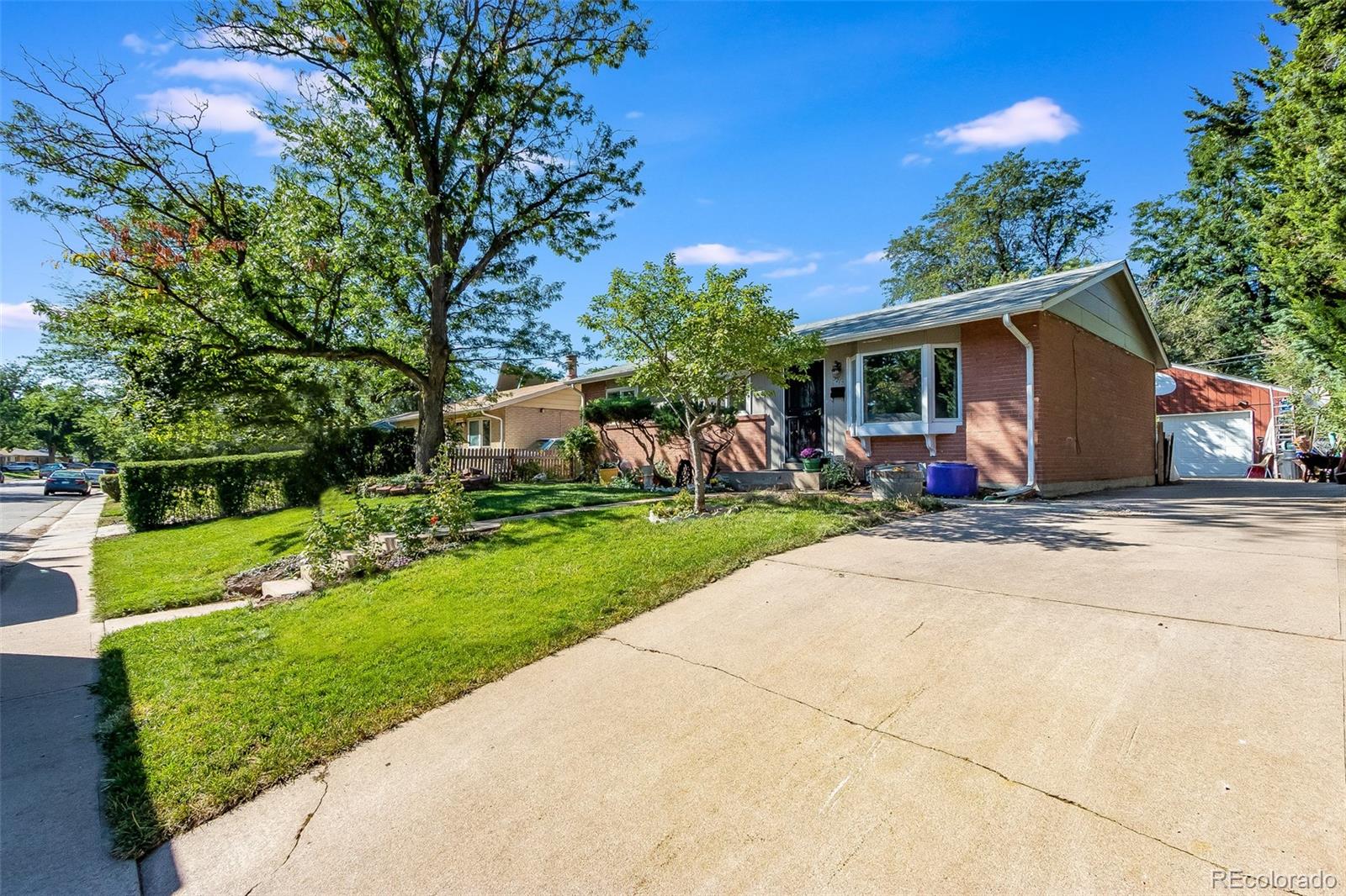 3217 South Stuart Street Denver, CO 80236 - Photo 2 of 30 a view of a house with backyard and garden