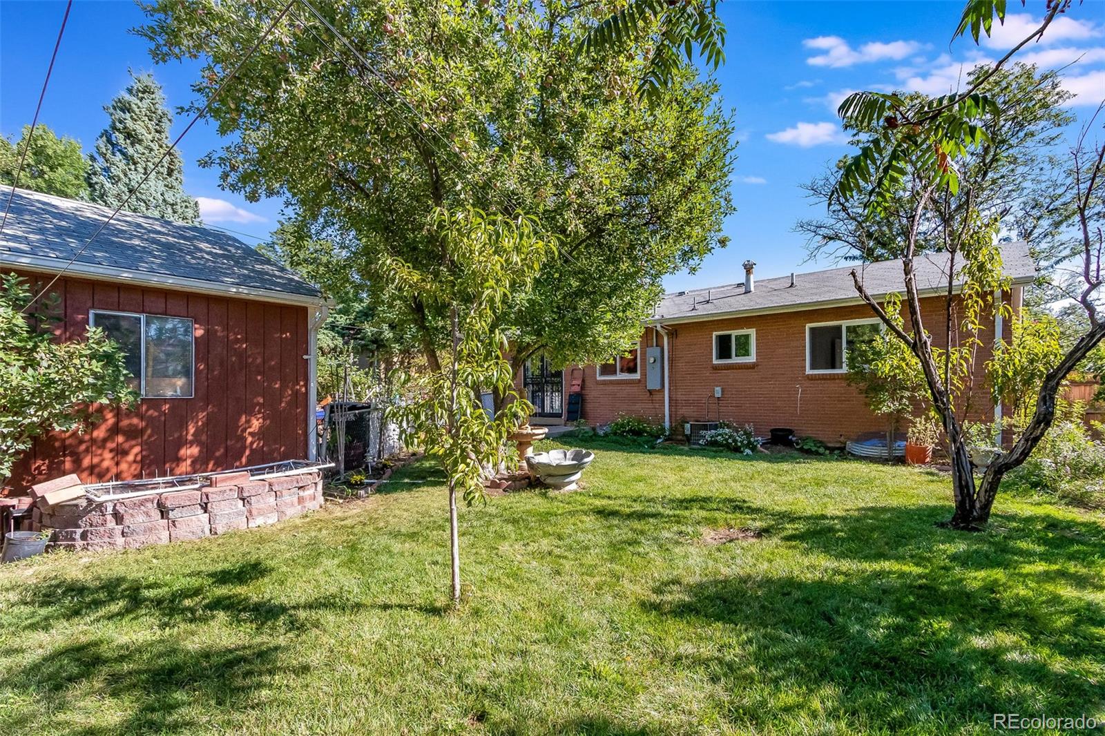 3217 South Stuart Street Denver, CO 80236 - Photo 30 of 30 a backyard of a house with yard and outdoor seating
