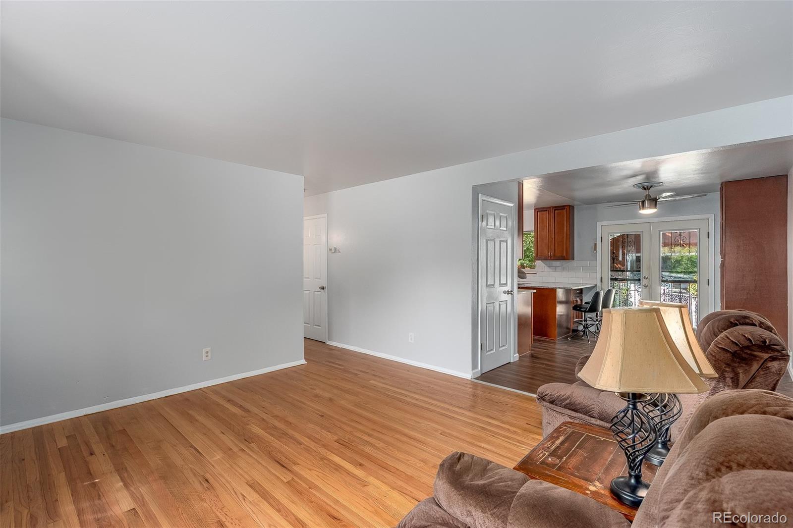 3217 South Stuart Street Denver, CO 80236 - Photo 7 of 30 a living room with furniture and a wooden floor