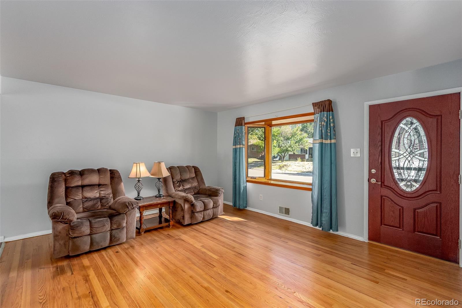 3217 South Stuart Street Denver, CO 80236 - Photo 8 of 30 a bed room with furniture and a window