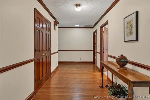 a spacious bedroom with furniture and a large window