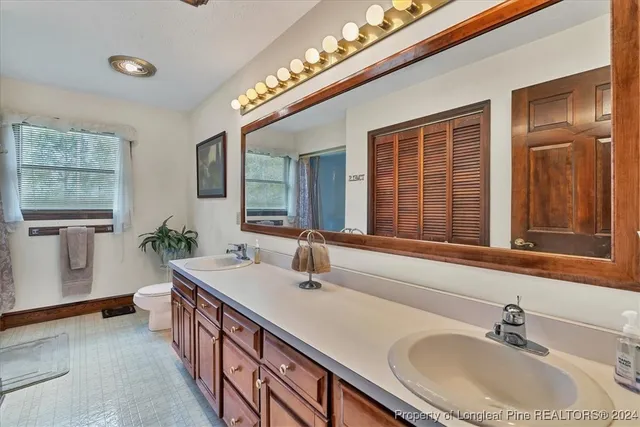 a living room with furniture and dresser