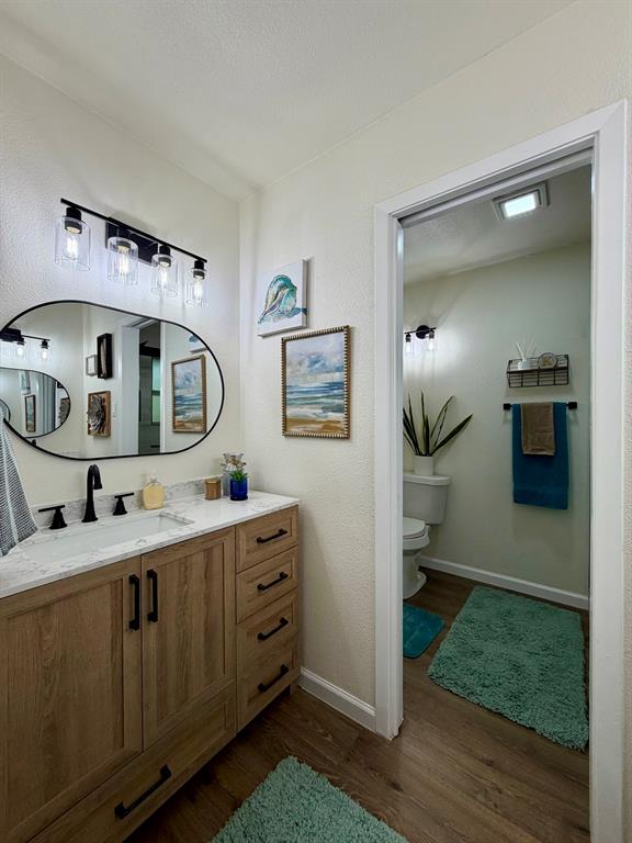 3609 Country Club Road Arlington, TX 76013 - Photo 24 of 40 a en suite bathroom with a double vanity sink and a mirror