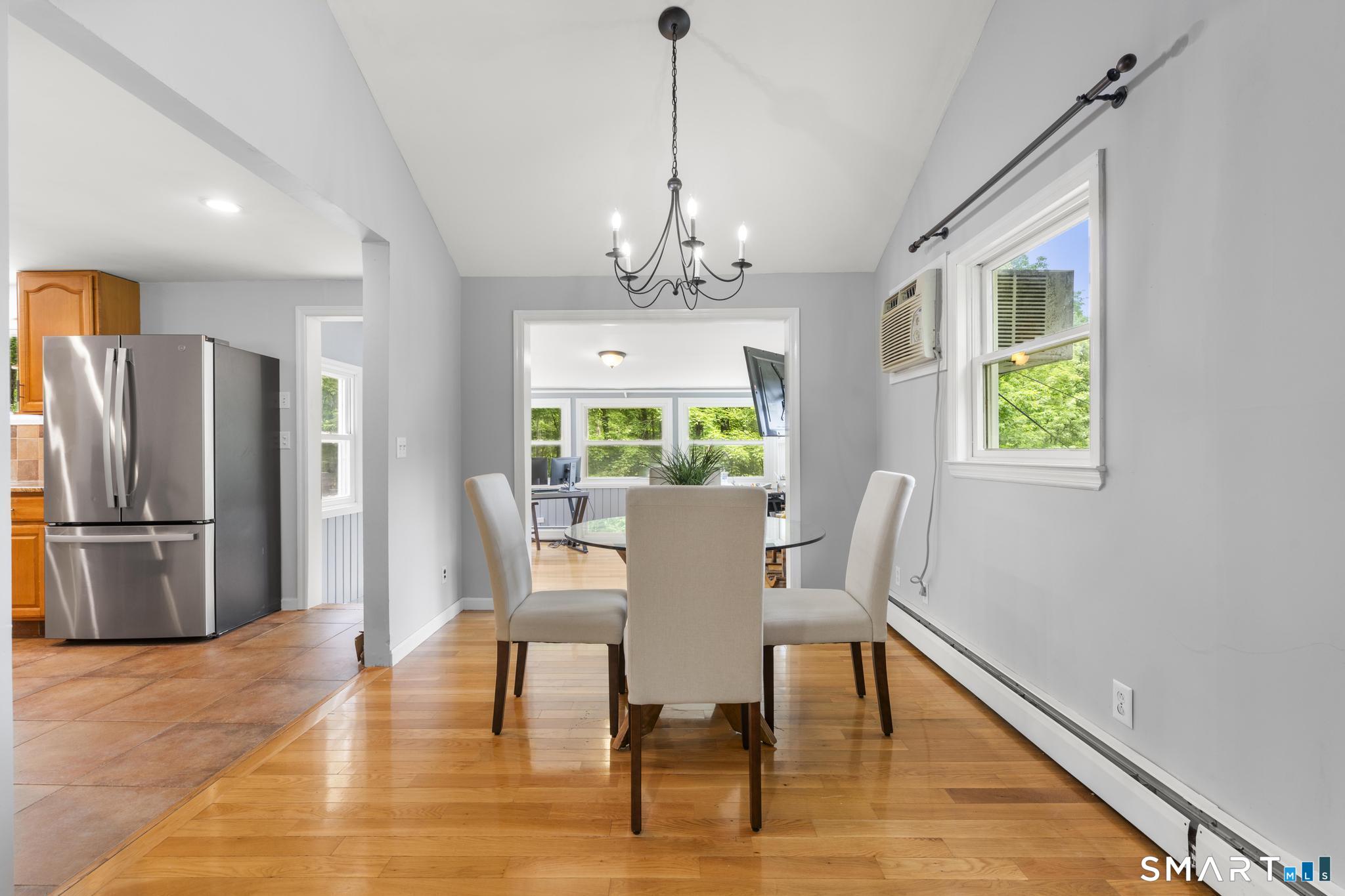 200 Old Huckleberry Road Wilton, CT 06897 - Photo 6 of 24 a dining room with furniture a window and wooden floor
