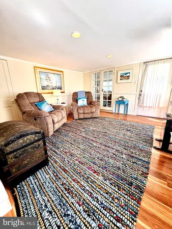a view of a bedroom with wooden floor and windows