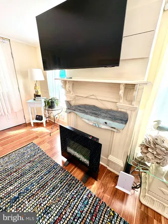 a kitchen with granite countertop a sink cabinets and wooden floor