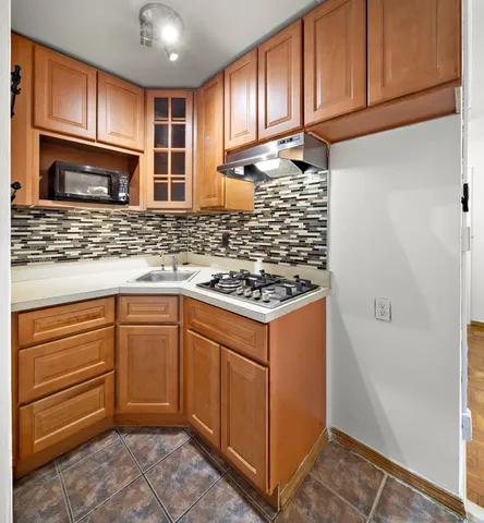 a kitchen with stainless steel appliances granite countertop a refrigerator and a stove