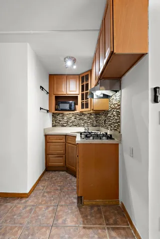 a kitchen with stainless steel appliances kitchen island granite countertop a refrigerator and a sink