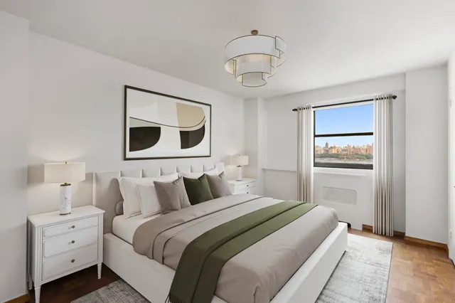 a bedroom with a bed and a painting on the wall