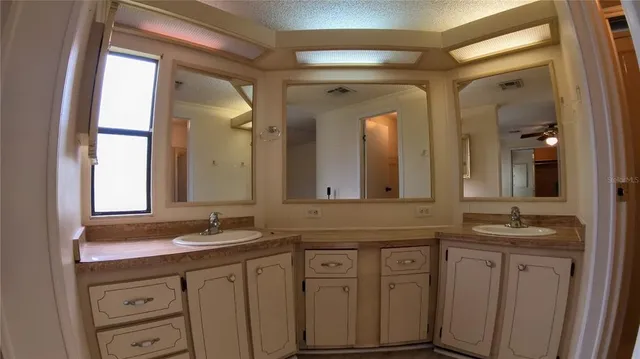 a bathroom with a granite countertop sink double and mirror