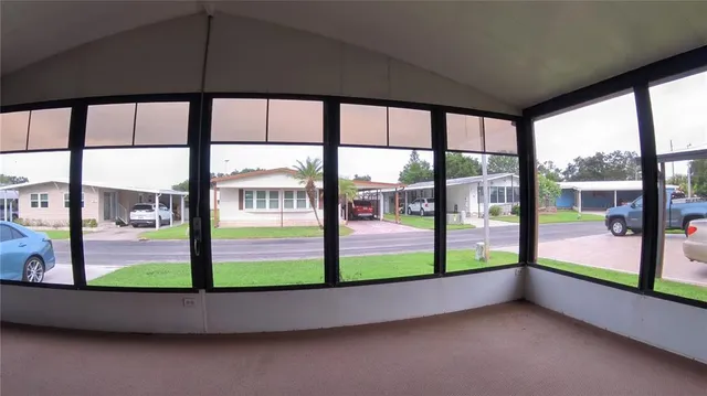 a view of an empty room with a floor to ceiling window