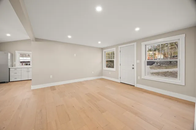 an empty room with windows and closet
