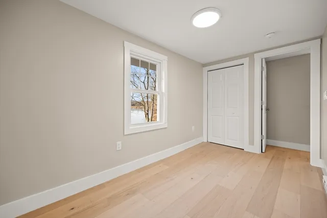 an empty room with windows and closet