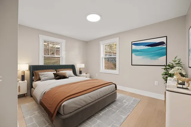 a bedroom with bed and painting on the wall