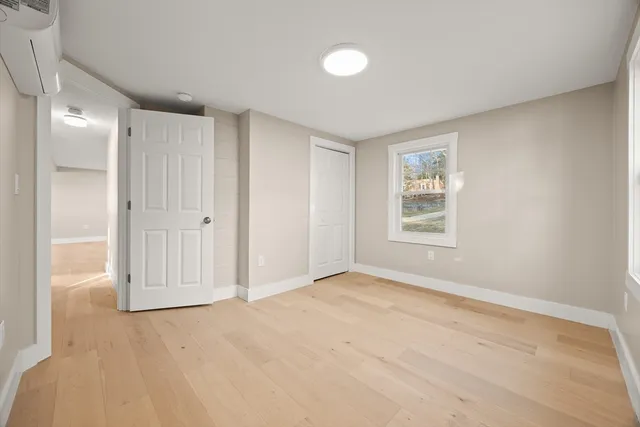 an empty room with windows and closet