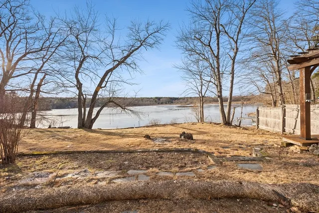 a view of yard covered with snow in front of house