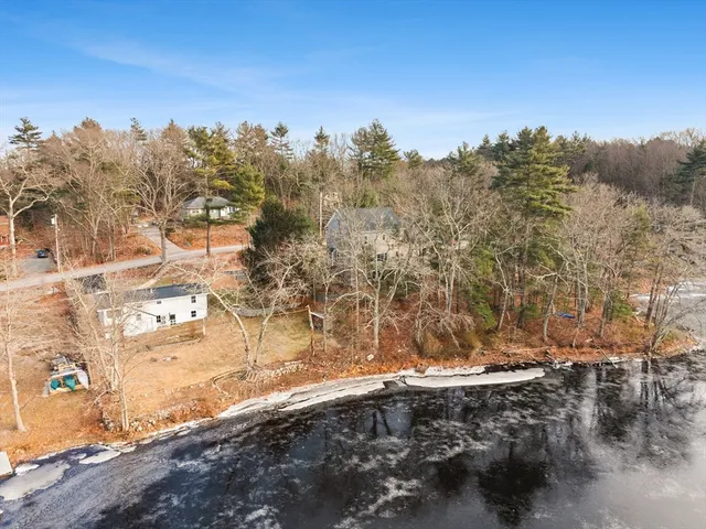 a view of a yard with wooden fence