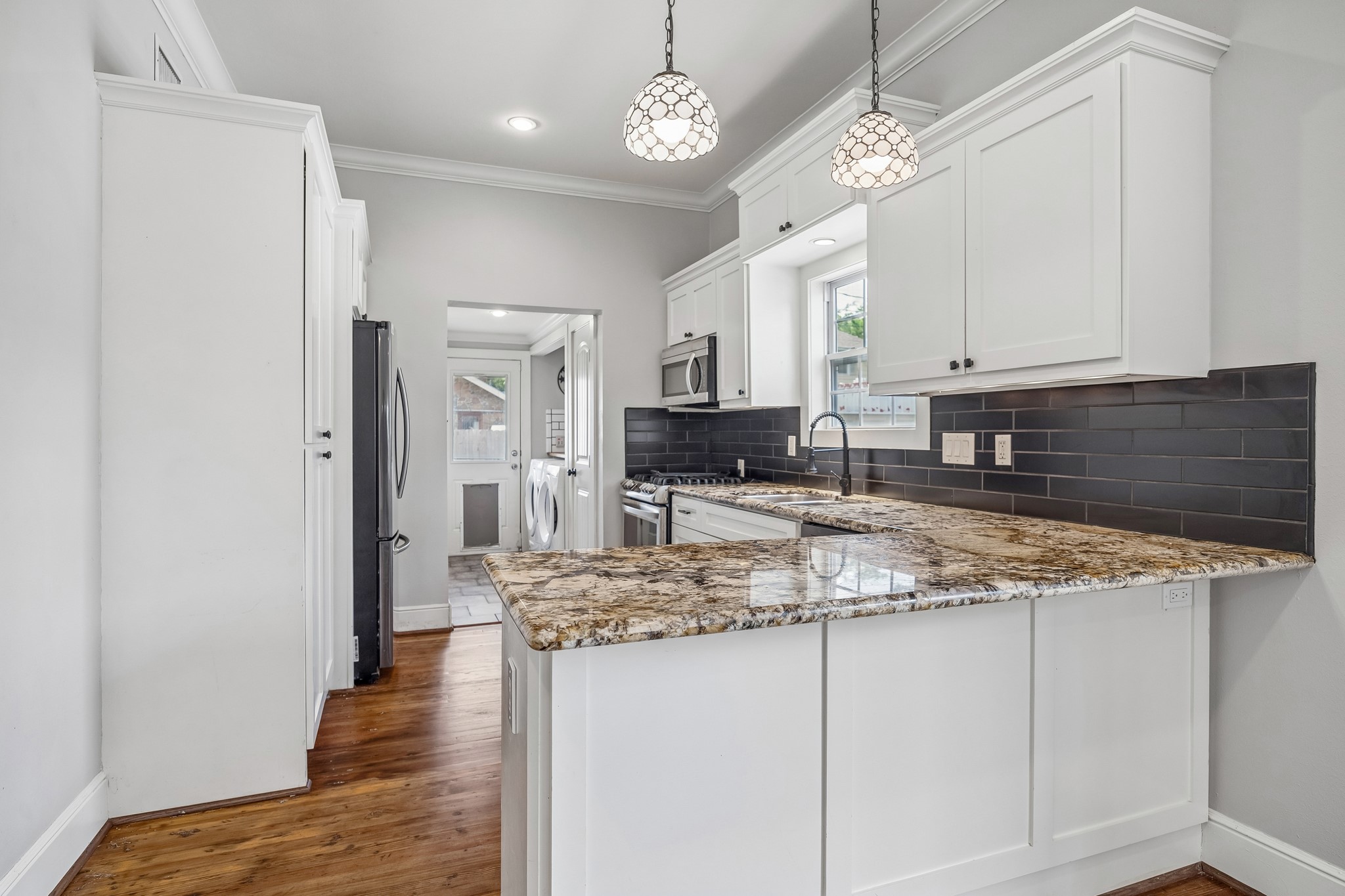 4412 Rusk Street Houston, TX 77023 - Photo 12 of 44 Another view of renovated kitchen, boasting beautiful cabinetry, large pantry & upgraded hardware.
