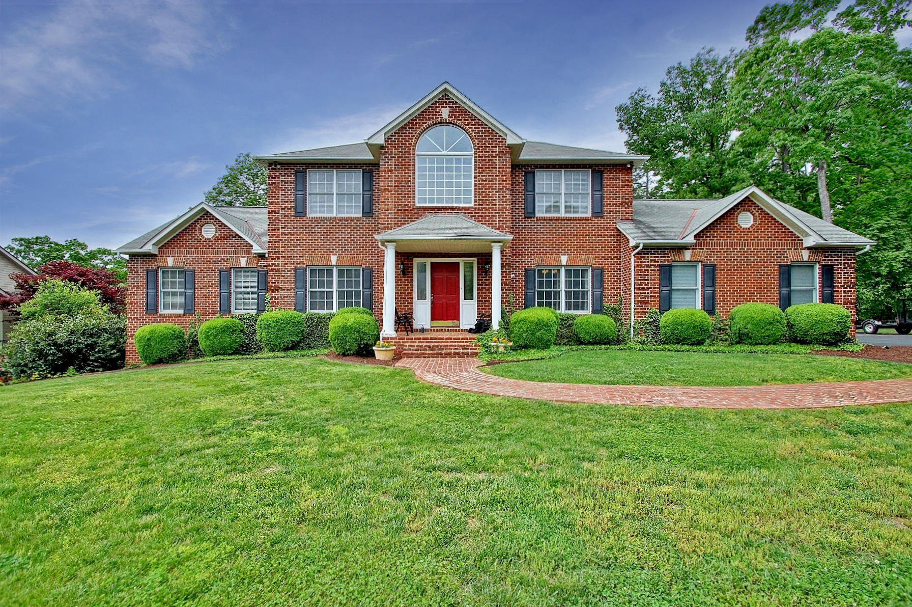 425 Stonehaven Lane Blue Ridge, VA 24064 - Photo 1 of 50 a front view of a house with a yard and trees