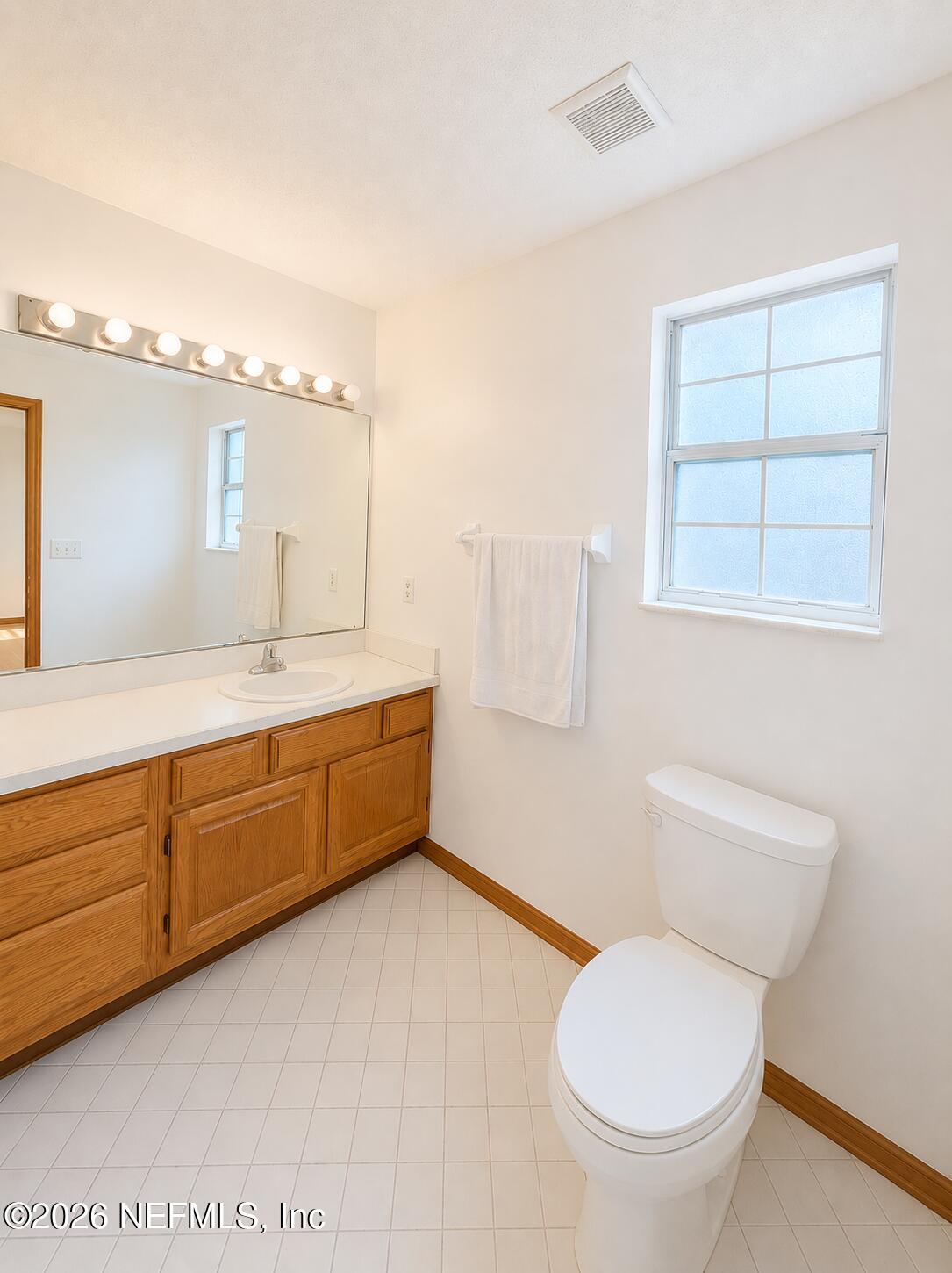 6 Surfcrest Street St. Augustine Beach, FL 32080 - Photo 9 of 15 a bathroom with a toilet sink and mirror