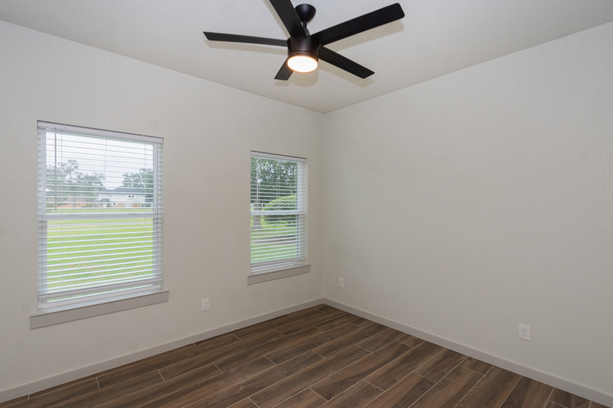 2190 Riverside Drive West Columbia, TX 77486 - Photo 31 of 39 a view of an empty room with wooden floor and a window