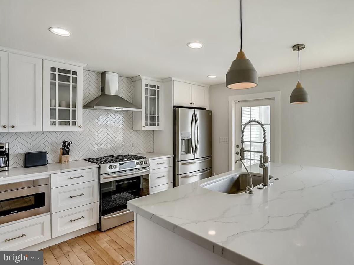 21642 Chicken Point Road Tilghman, MD 21671 - Photo 16 of 63 a kitchen with stainless steel appliances granite countertop a stove a sink and a refrigerator