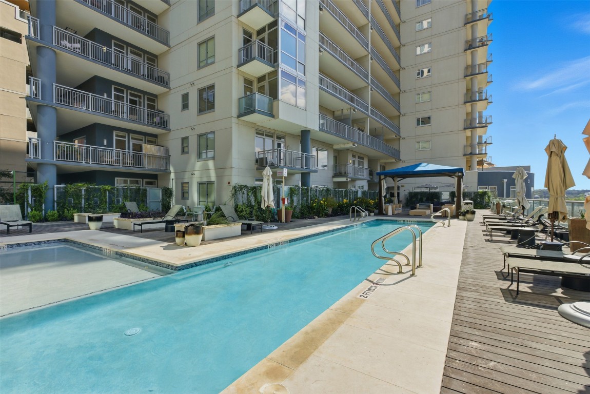a view of a building with sitting area and garden