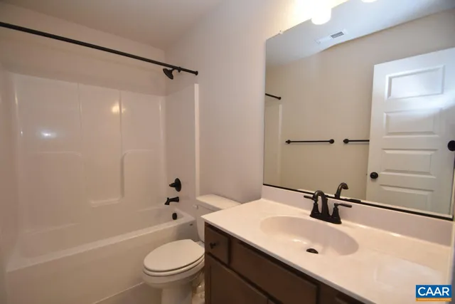 a bathroom with a sink toilet tub and shower