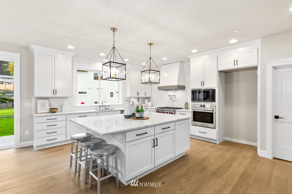 22915 31st Avenue Southeast Bothell, WA 98021 - Photo 14 of 40 a kitchen with white cabinets stainless steel appliances and kitchen island