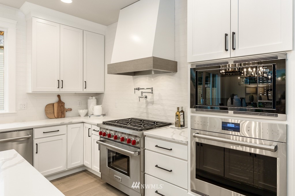 22915 31st Avenue Southeast Bothell, WA 98021 - Photo 16 of 40 a kitchen with stainless steel appliances granite countertop a stove and a microwave