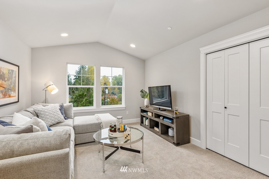 22915 31st Avenue Southeast Bothell, WA 98021 - Photo 27 of 40 a living room with furniture a flat screen tv and a large window