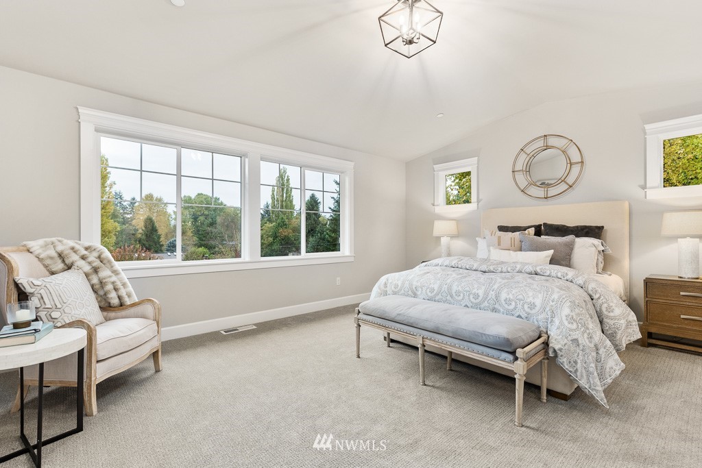 22915 31st Avenue Southeast Bothell, WA 98021 - Photo 28 of 40 a bedroom with a bed and a chandelier