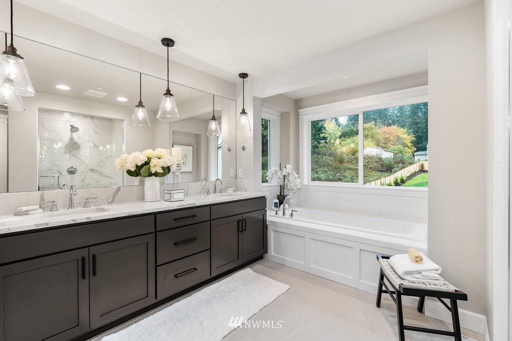 22915 31st Avenue Southeast Bothell, WA 98021 - Photo 30 of 40 a bathroom with a double vanity sink large mirror and a bathtub