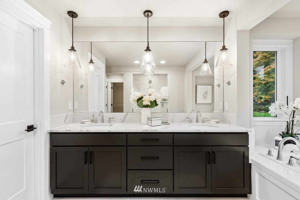 22915 31st Avenue Southeast Bothell, WA 98021 - Photo 33 of 40 a bathroom with a sink tub vanity and a mirror