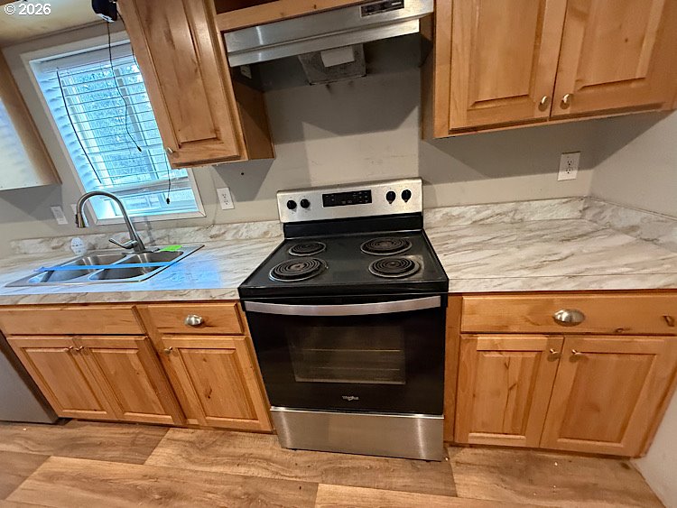 16125 Hawks Lair Road La Pine, OR 97739 - Photo 12 of 35 a stove top oven sitting inside of a kitchen