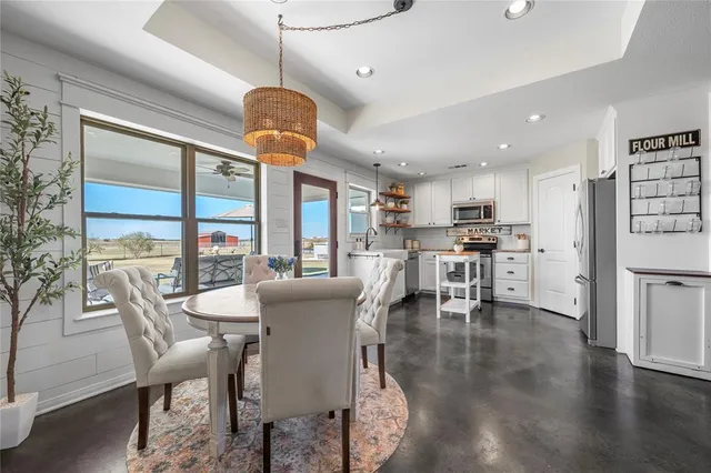 a dining room with furniture and a kitchen view