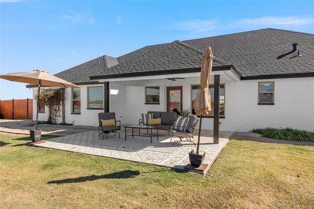a view of a terrace with lawn chairs