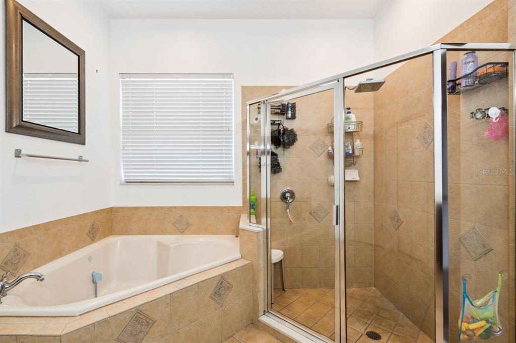 8484 Dover View Lane Orlando, FL 32829 - Photo 22 of 41 a bathroom with a bathtub and a shower
