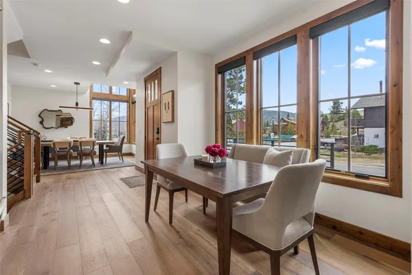 a view of a a dining room with furniture window and wooden floor