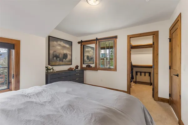 a spacious bedroom with a large bed and a dresser