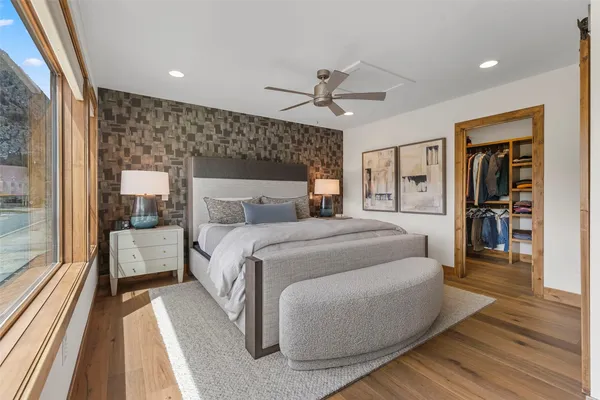 a bedroom with a large bed and a large window