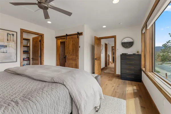 a bedroom with a large bed and a chandelier