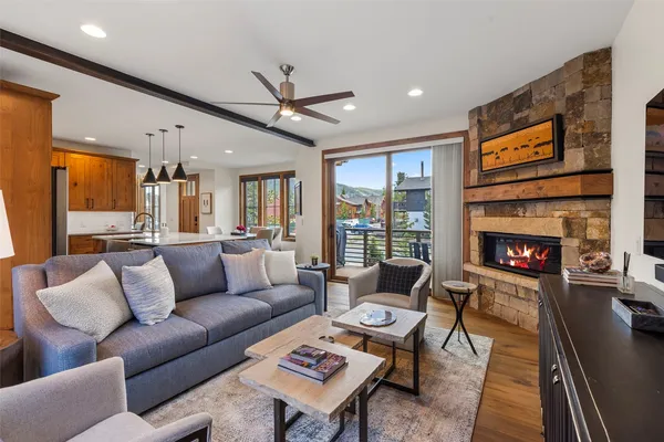 a living room with furniture a large window and a fireplace