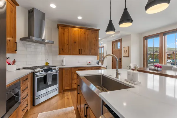 a kitchen with a stove a sink and a microwave