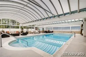 a view of a swimming pool with seating space