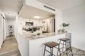 a kitchen with kitchen island granite countertop a sink and cabinets